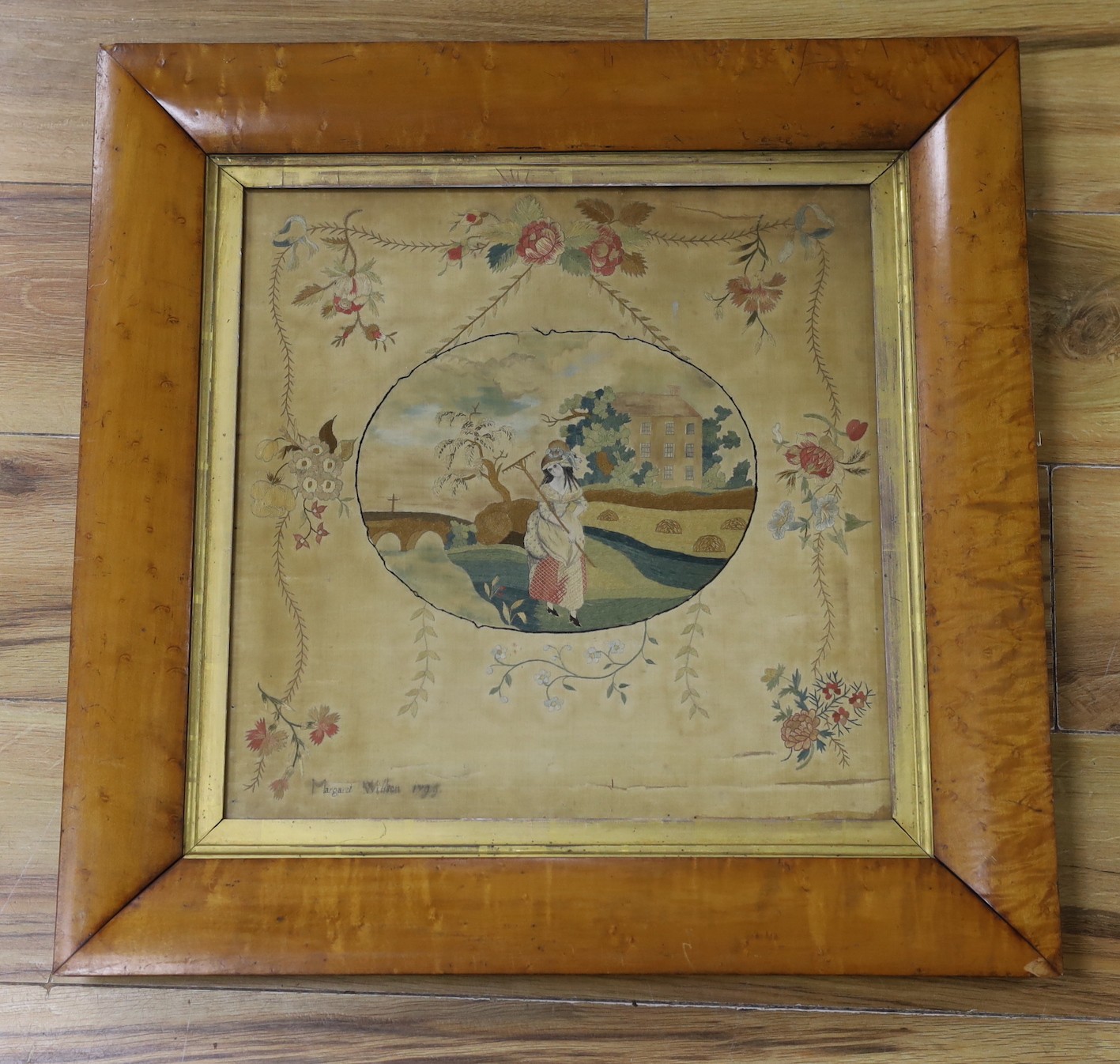 A maple framed George III silk panel of lady in harvest by Margaret Wilson, 1799inscription verso, 37 x 37cm